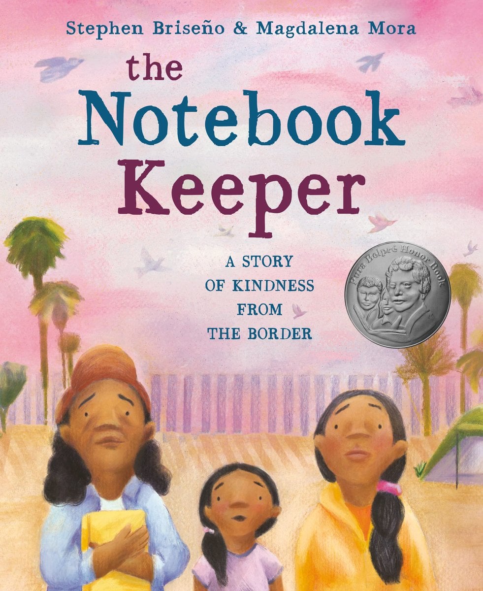 The Notebook Keeper by Stephen Briseno and Madalena Mora book cover features a pink and purple sunset with sand and palm trees in the background as a group of three people -- two women and a girl look up at something in awe. The woman on the left holds closely a yellow notebook to her chest. The title is in blue and purple font with the words "A story of kindness from the border" below it. The author and illustrator names are at the very top in matching blue.