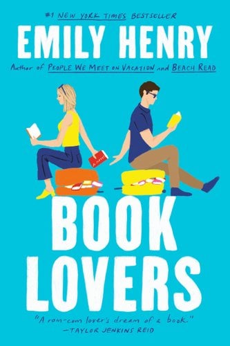 A blue book cover with a drawing of two people sitting on suitcases overflowing with books. It says "Book Lovers" on the bottom.