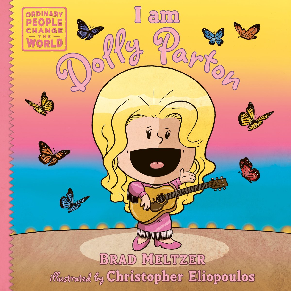 Book cover of "I am Dolly Parton," written by Brad Meltzer and illustrated by Christopher Eliopoulos, featuring a light-skinned child-like figure with blond hair and wearing a pink fringed dress singing while playing an acoustic guitar; colorful butterflies are fluttering around her.