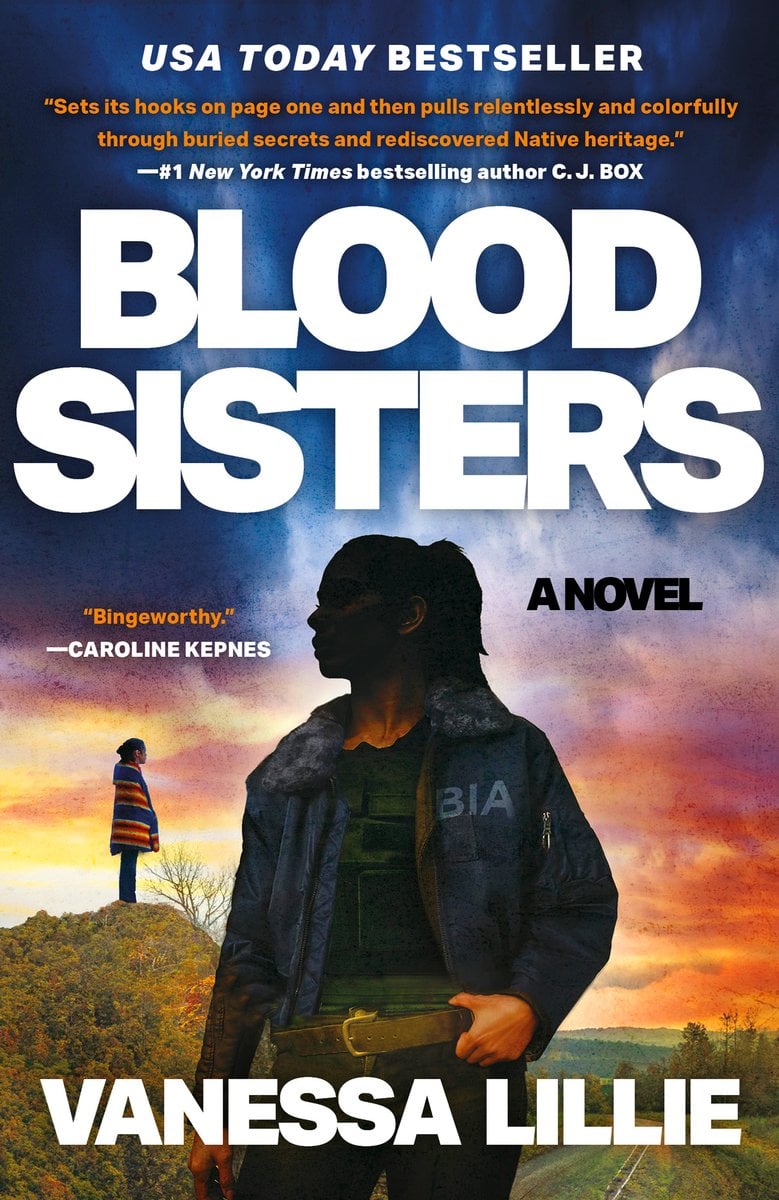 Blood Sisters by Vanessa Lillie book cover presents a silhouette of a woman wearing a Bureau of Indian Affairs (BIA) jacket. She stands against a dramatic sky that transitions from deep blues to fiery oranges and purples. In the background, a second figure is visible in the distance.