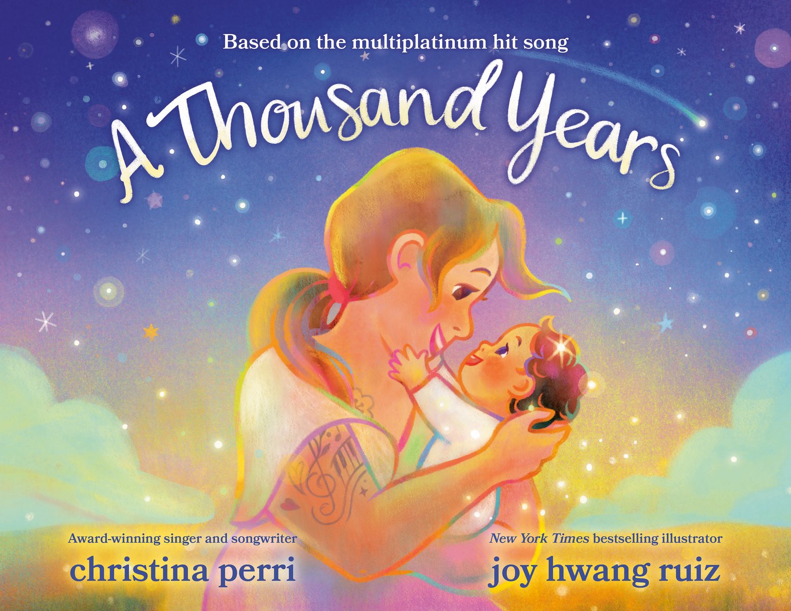 Book cover of A Thousand Years by Christina Perri, Illustrated by Joy Hwang Ruiz, featuring a light-skinned adult with long, straight blonde hair cuddling an infant with short, dark, curly hair. The adults has visible tattoos on their upper arm. The background is a dreamy starry night sky.