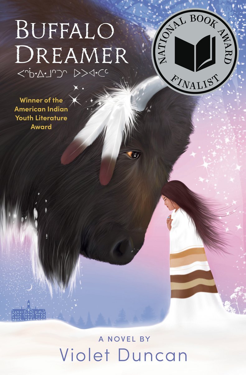 The book cover of "Buffalo Dreamer" by Violet Duncan features a tan-skinned girl with long dark hair and wearing an Indigenous blanket around her shoulders, resting her forehead against a gigantic black buffalo with eagle feathers hanging from its horns, visible in the far background of the snowy setting is a silhouetted schoolhouse.