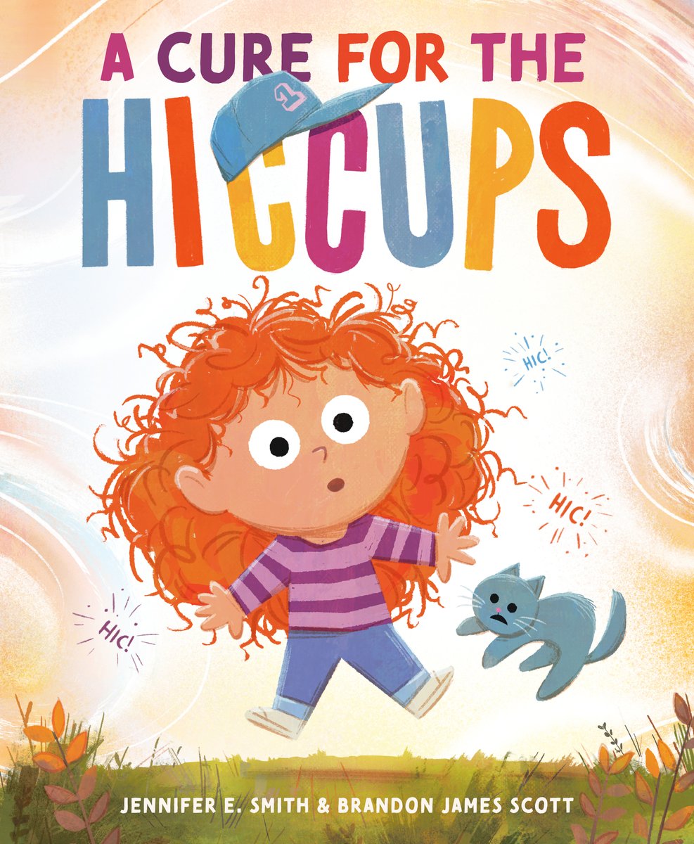A Cure for the Hiccups book cover features an outside landscape with a girl that has frizzy, curly red hair. Next to her is a gray cat, perked up like it's scared. A cap is flying off her head into the title that is in all all caps in blue, red, yellow, and purple colors.