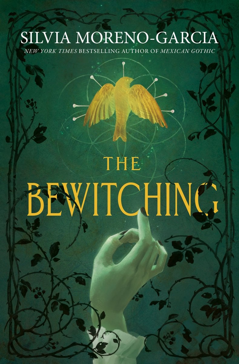 The Bewitching by Silvia Moreno-Garcia, book cover. Emerald background with black decayed flowers bordering a glowing hand and a gold illuminated bird. The title "The Bewitching" is written in the same gold.