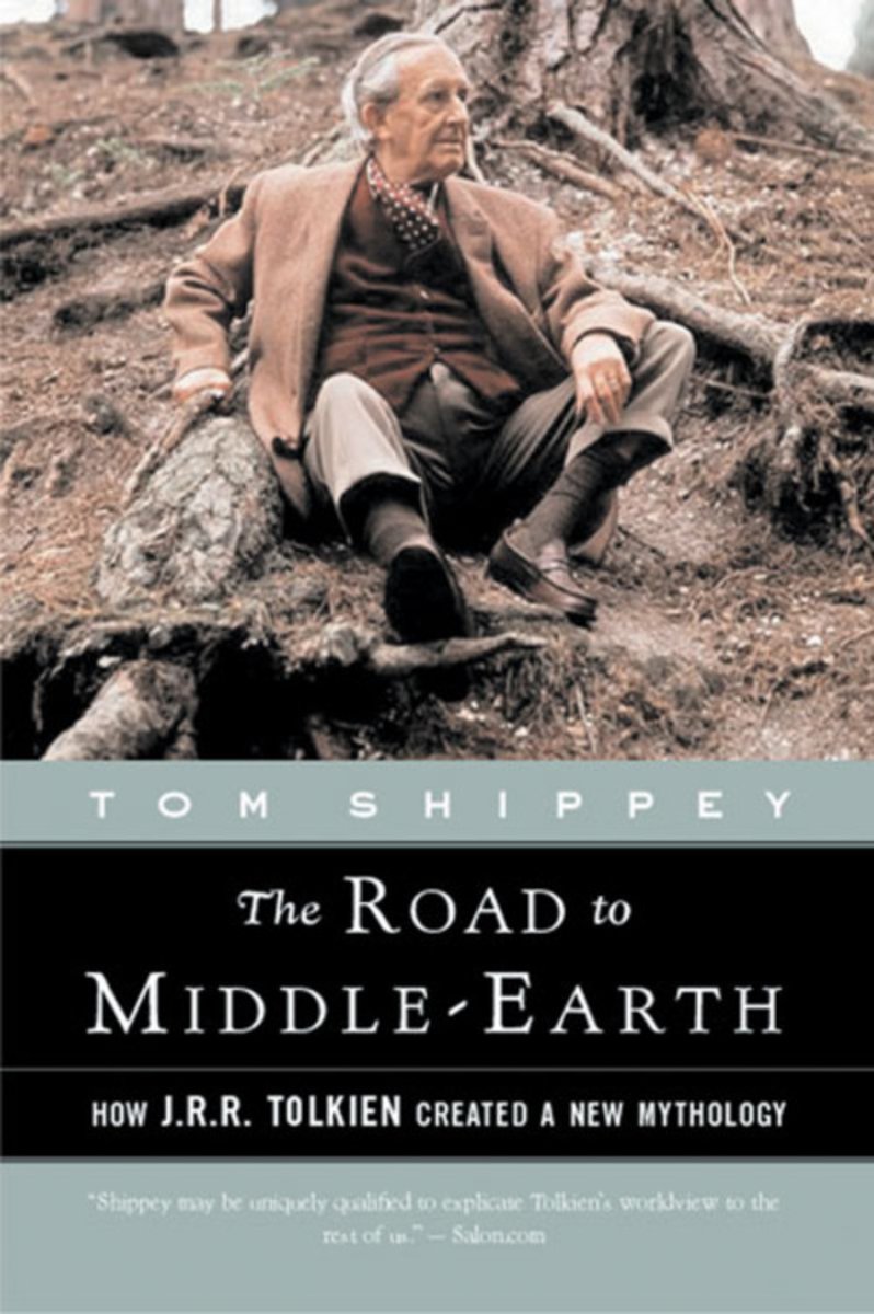 The cover of The Road to Middle Earth. There is a colored photo of an old Tolkien sitting underneath a large tree, tucked between gigantic roots and looking off into the distance.