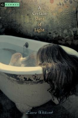 "A Certain Slant of Light" by Laura Whitcomb conveys a muted, beige-toned cover with an eerie mood. In a worn white claw-foot bathtub, a figure with long brown hair leans over the rim, face obscured with their back leaning against the tub. Aged wallpaper with faint floral patterns fills the background. Small stacked white text near the top reads the title and the author’s name appears in delicate script at the bottom.