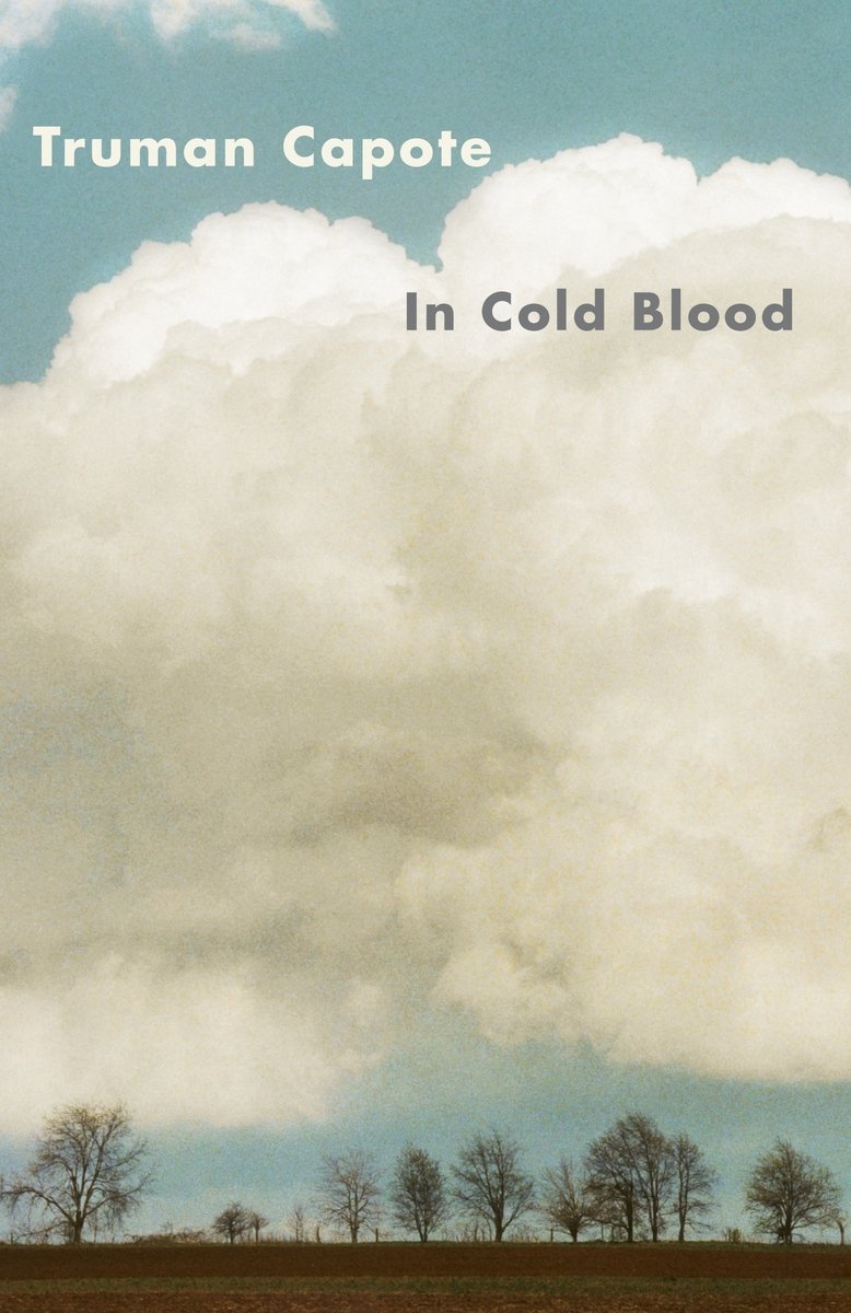 In Cold Blood by Truman Capote. The cover is a picture of a sky with a big white cloud and trees at the bottom.
