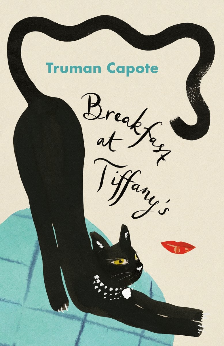 Cover of "Breakfast at Tiffany’s" by Truman Capote. A black cat is stretching on a blue cushion. The cat is wearing a pearl necklace.