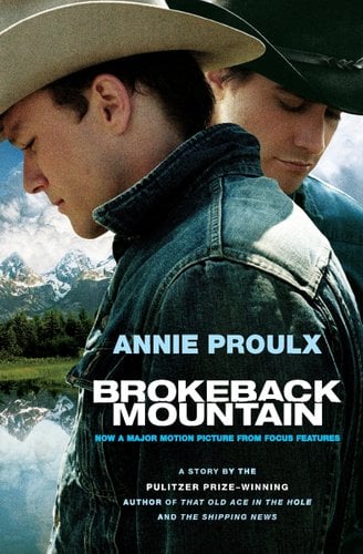Two men stand in front of a mountain, one facing forward and the other behind him, both gazing downward contemplatively.