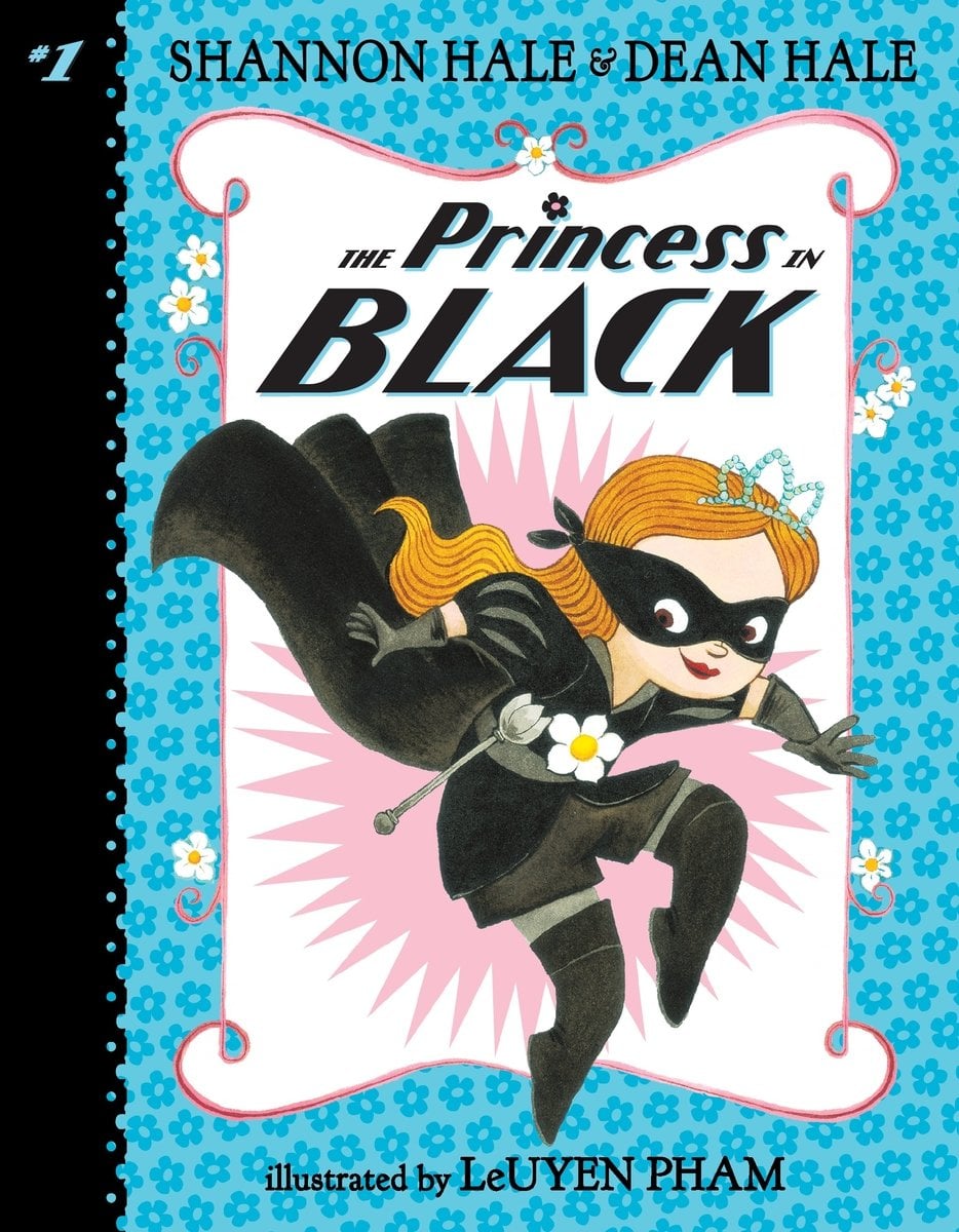 The Princess in Black by Shannon Hale and Dean Hale, a children's book cover depicting a girl with ginger hair wearing a black mask, outfit, and cape, tiptoeing on a blue floral background with a white and pink frame in the center.