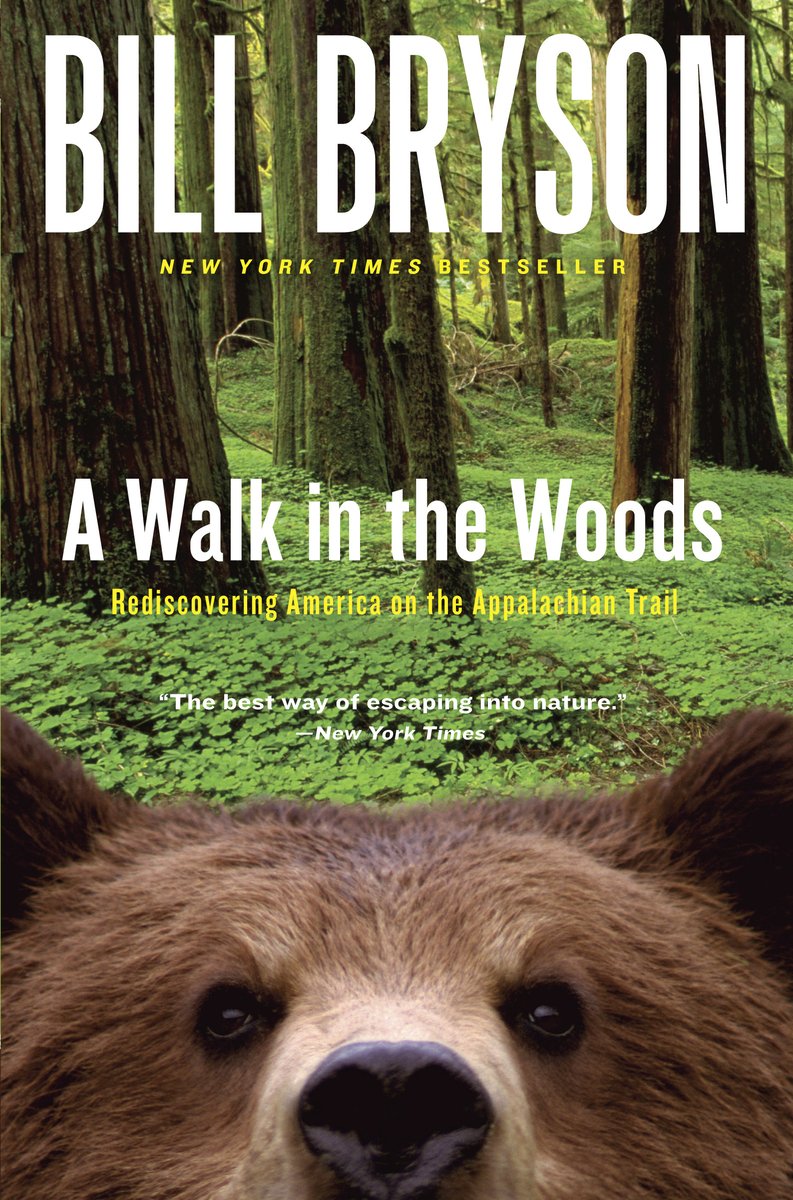 A Walk in the Woods y Bill Bryson book cover depicting the forest floor of Appalachian mountains with a bear face looking up from the bottom into the camera.