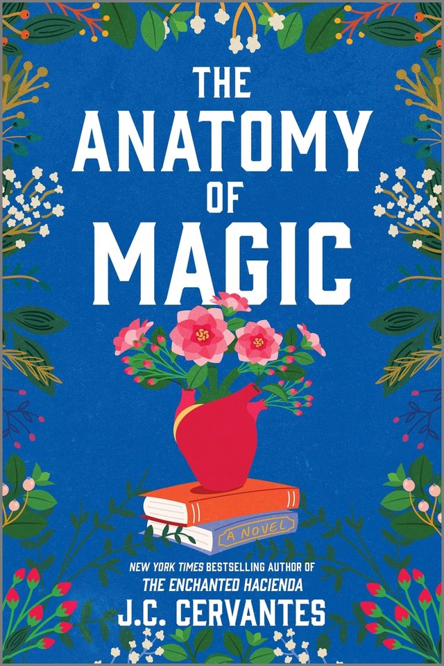 Cover of The Anatomy of Magic by J. C. Cervantes. A vase of flowers sits on a stack of two books. The background is blue with flowers surrounding the frame. 