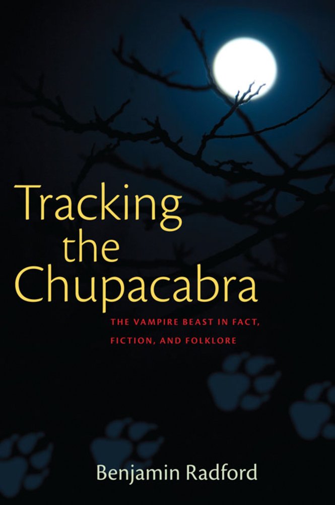The book cover of "Tracking the Chupacabra" by Benjamin Radford. A simple dark sky with a glowing white moon peeks behind black tree branches. The title text is yellow.