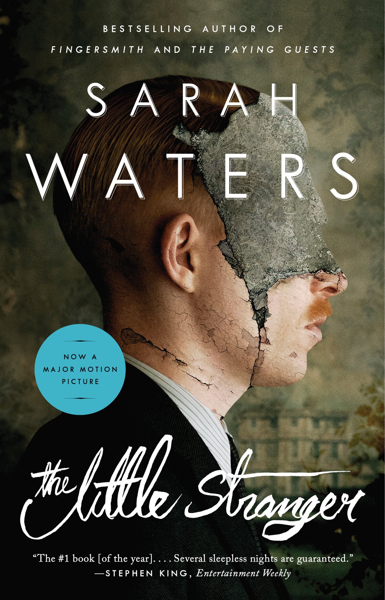 Cover of The Little Stranger by Sarah Waters. Side profile of a man, with his face covered by stone. A house is in the background.