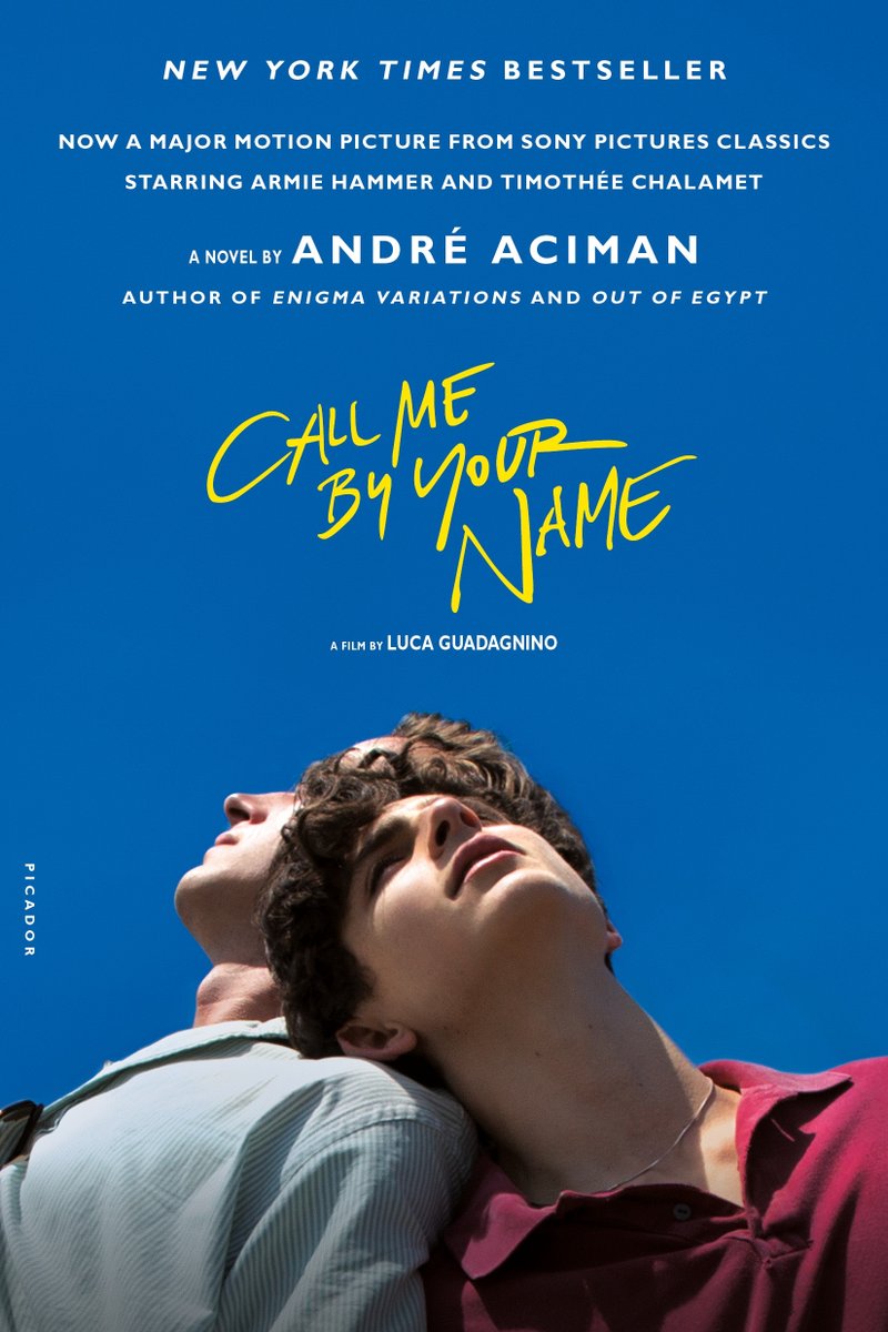 call me by your name book cover blue background with two men leaning on each other looking up from the bottom with yellow title text above them