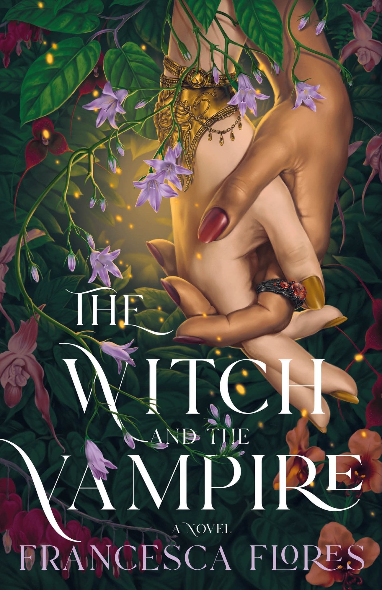 Book cover of The Witch and the Vampire by Francesca Flores. The cover shows hands from two different women in a thoughtful embrace surrounded by leafy branches and vibrant flowers while illuminated by something magical.