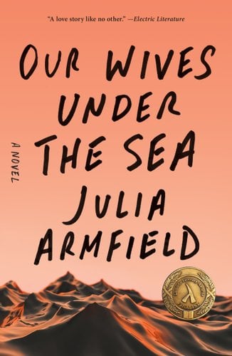 Book jacket for Our Wives Under the Sea by Julia Armfield. Ocean waves take up the bottom of the cover in front of an orange sky.