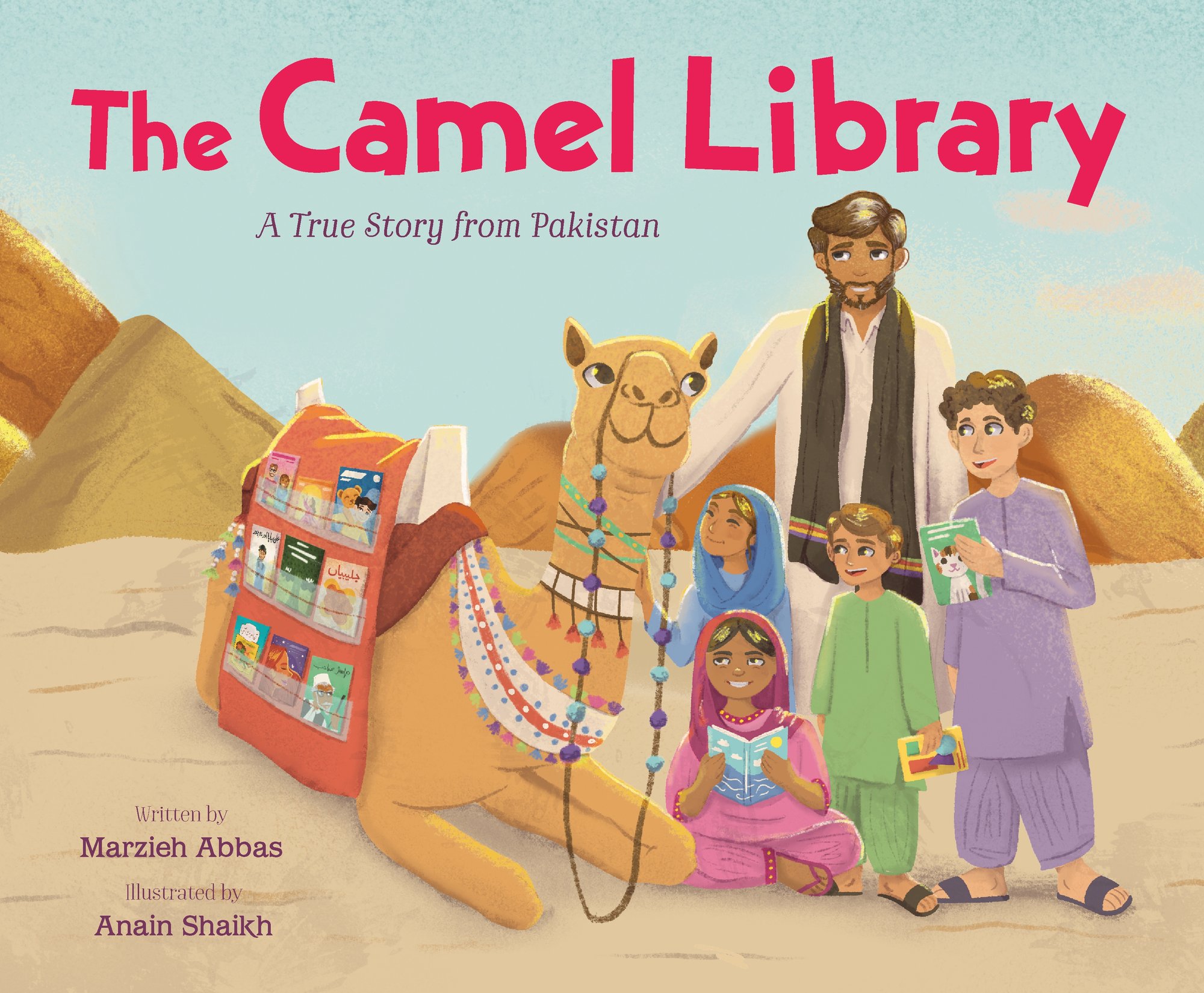 Book cover of The Camel Library: A True Story from Pakistan by Marzieh Abbas, Illustrated by Anain Shaikh, featuring a large tan camel with a special blanket displaying books lying on the sand next to a brown-skinned adult with short, straight brown hair and several children of various skin tones and hair colors reading books.