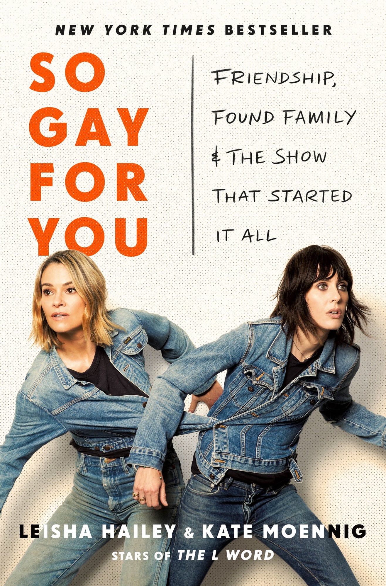 So Gay for You: Friendship, Found Family, and the Show That Started It All by Kate Moennig & Leisha Hailey shows the title on the top half and the two authors on the bottom half. They are posed looking at opposite ends in a slight crouch position with their jean jackets buttoned together.
