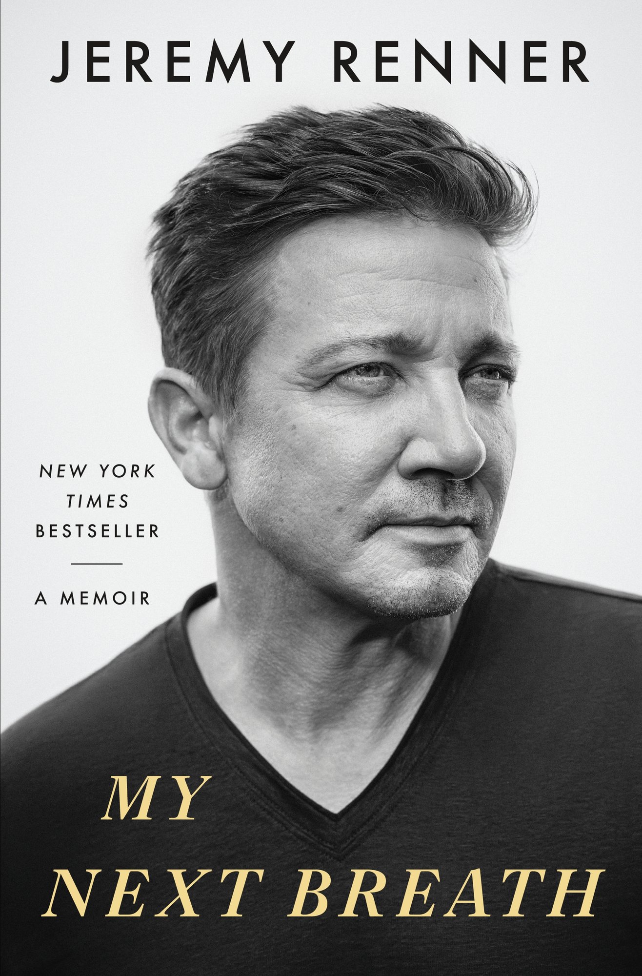 The book cover for My Next Breath shows a portrait of Jeremy Renner in a black t-shirt, looking off to the side introspectively.
