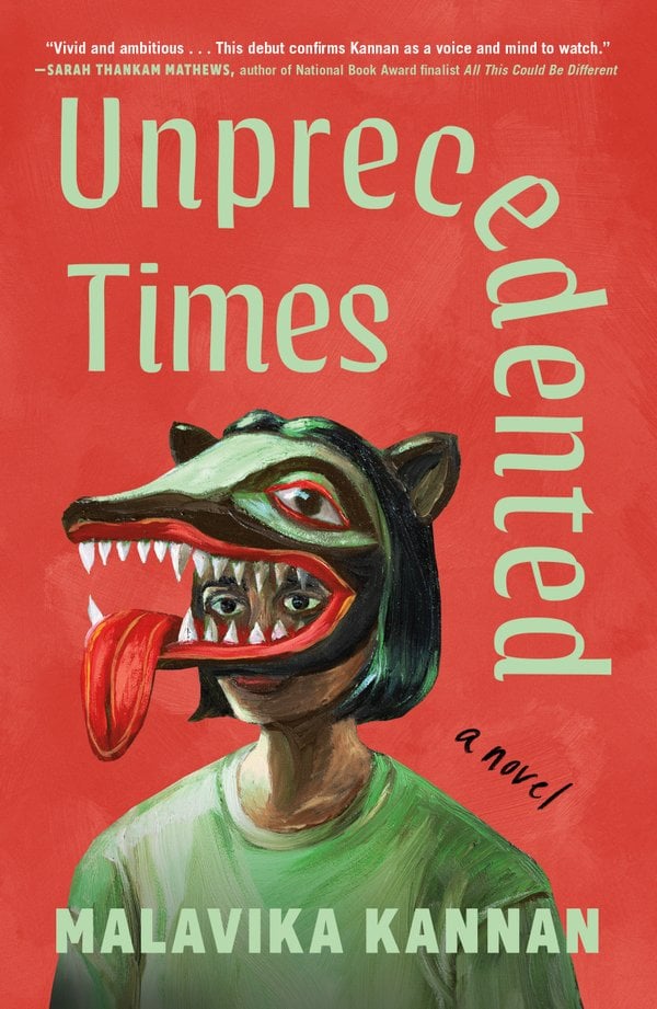 Unprecedented Times by Malavika Kannan, a fiction book cover depicting art of a person with light brown skin and short black hair in a green shirt wearing a big mask of a wolf with sharp teeth and its tongue hanging out its mouth on their head, on a red background.