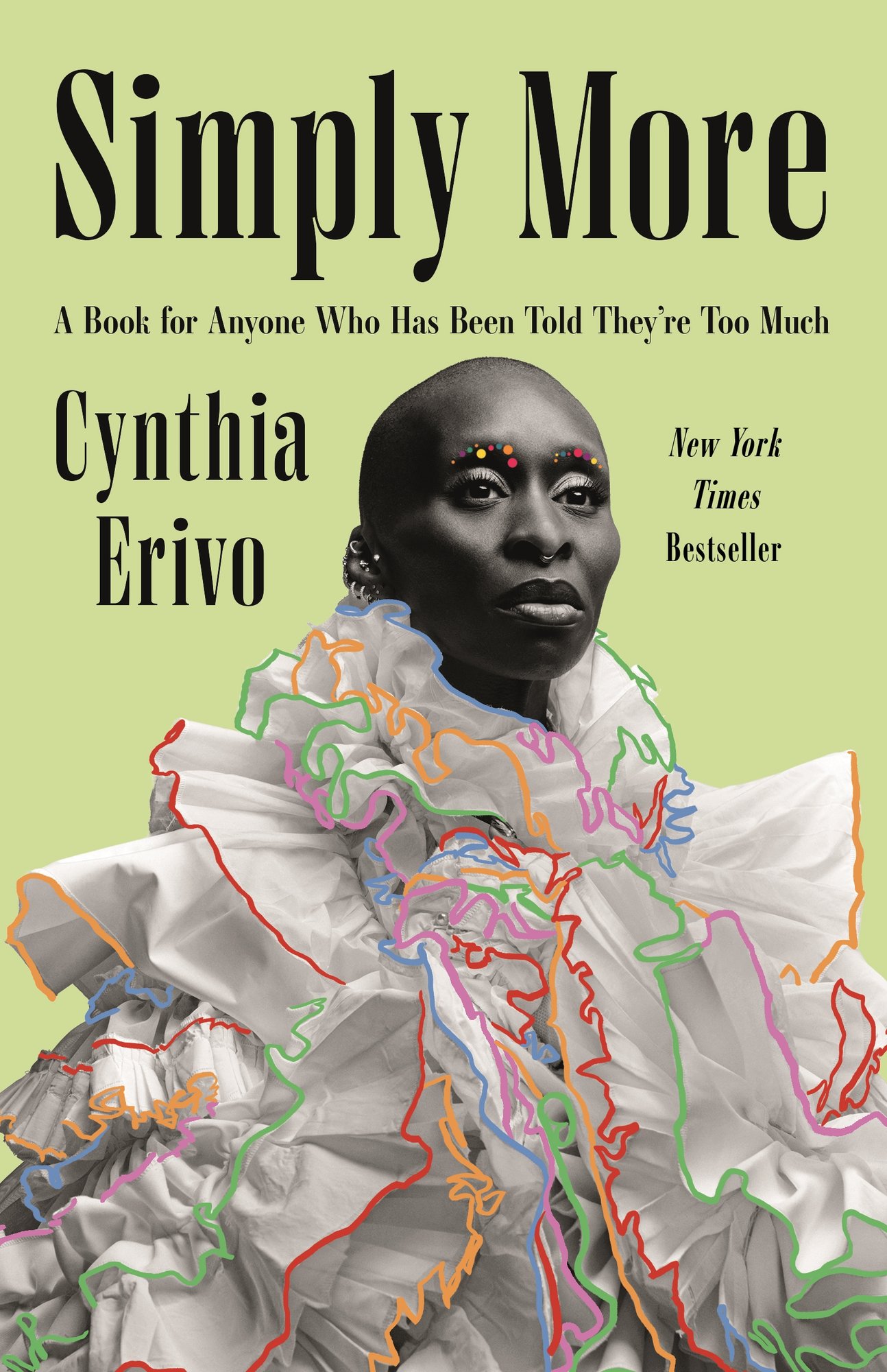 Simply More by Cynthia Erivo featuring a portrait of Cynthia with colorful jewels for eyebrows, and a large white ruffled blouse/dress with different colors lining the edges against a green background.