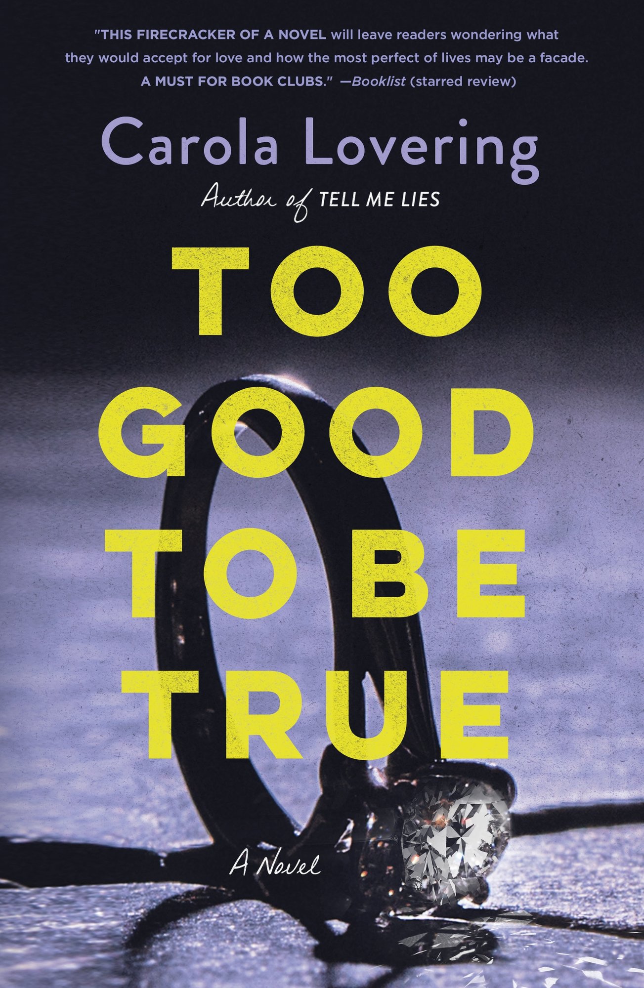Too Good to Be True by Carola Lovering book cover featuring a close up of a diamond ring on its side on a flat surface.