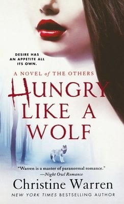 A cover of Hungry Like a Wolf by Christine Warren. The cover has half a woman's face on it wearing red lipstick. There is a wolf at the bottom/