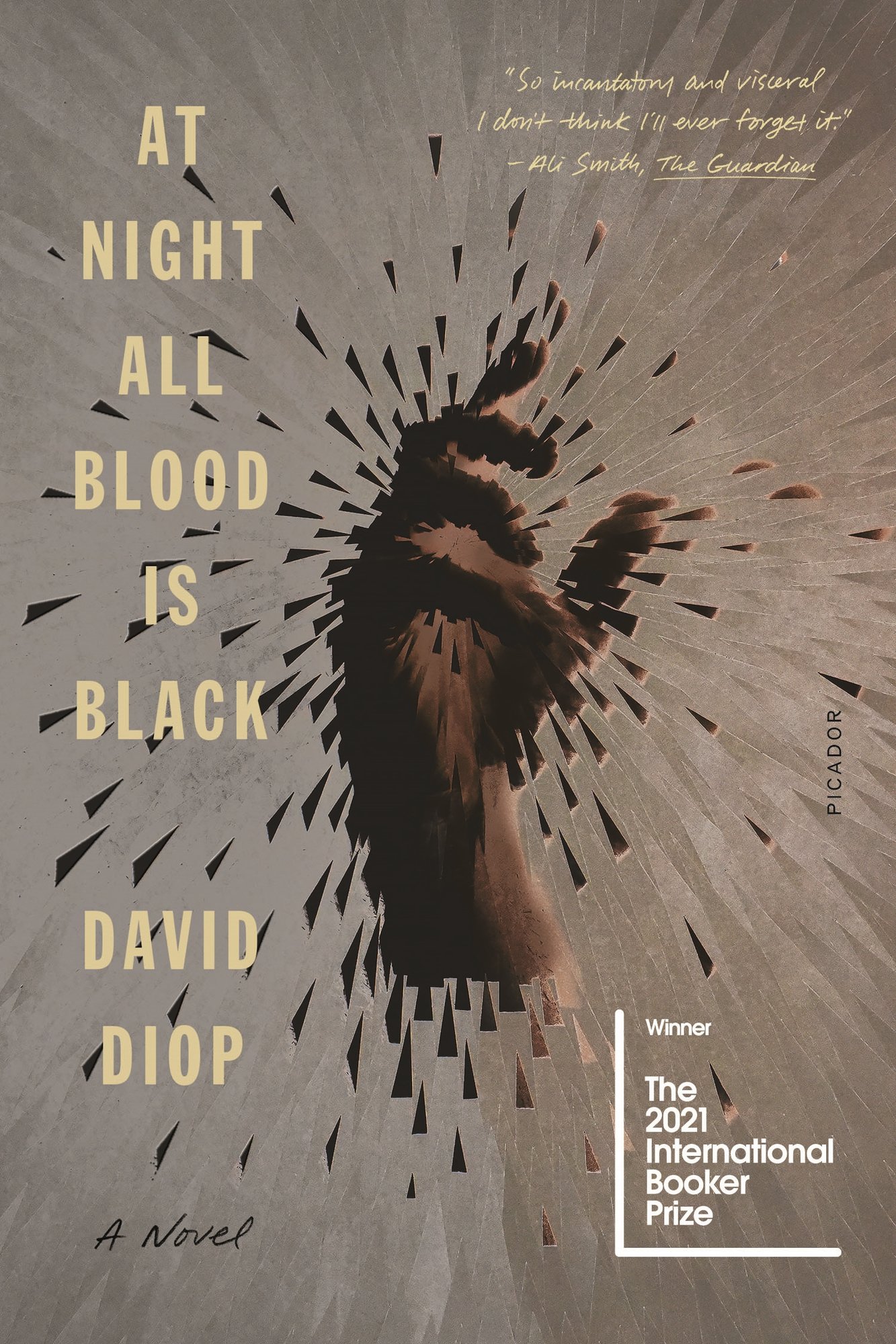 At Night All Blood is Black. A single grasping hand is visible at the cover's center, with shards the color of its skin tone emanating outwards in all directions.