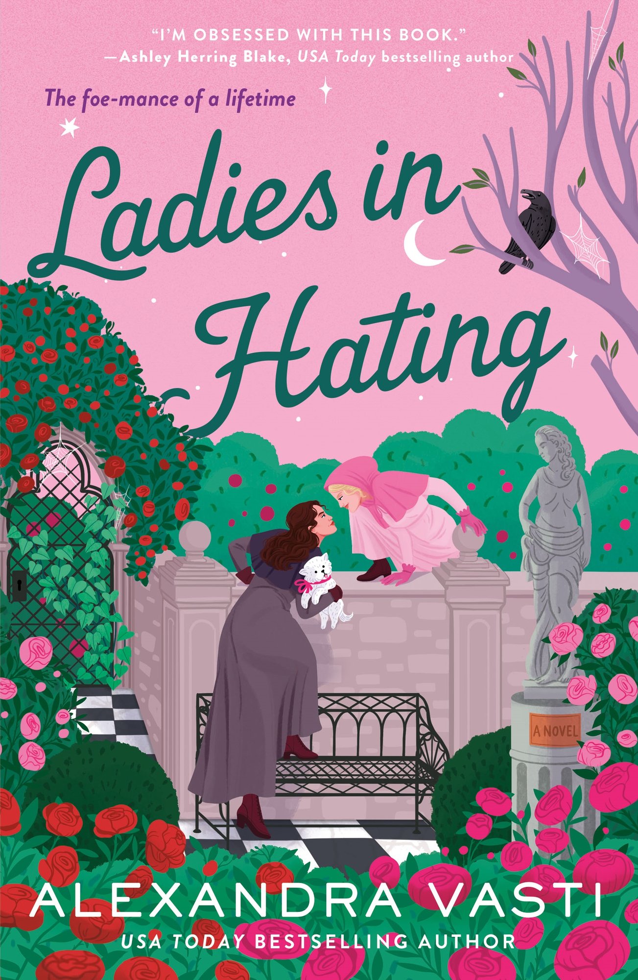Ladies in Hating by Alexandra Vasti historical romance book cover features two women facing each other across a garden wall: the brunette on the left is holding a small white dog, leaning over with one foot up on a metal bench while the blonde woman has a foot up on the wall and leaned over like she's climbing over. The garden around them is lush with rose bushes, flowers, and greenery. On the right side there’s a leafless tree with a spider web and a black bird among its branches. The title “Ladies in Hating” is prominently set in elegant green script across the top half, with the author’s name at the bottom.