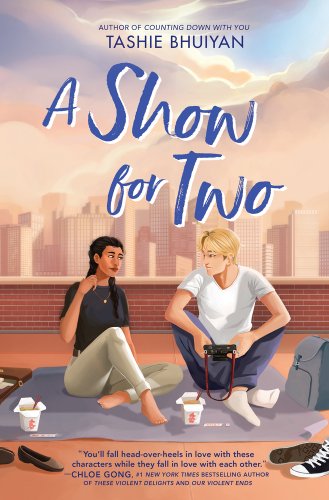 "A Show for Two" by Tashie Bhuiyan book cover of a city landscape with two teenagers sitting on a roof. Both boy and girl are talking as they eat Chinese food, sitting on a mat with their shoes off.