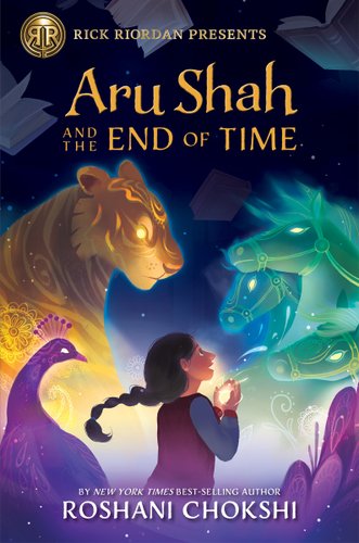 A dark blue book cover with several spirit figures of animals in purple, teal, and gold. In the middle is a drawing of a young girl with a braid holding something white and glowing.
