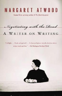 Negotiating with the Dead: A Writer on Writing by Margaret Atwood, a memoir book cover depicting the author sitting at a table and looking to the left of her. She is holding a notebook and the title and her name is hovering above her. The title is in black with her name in red.