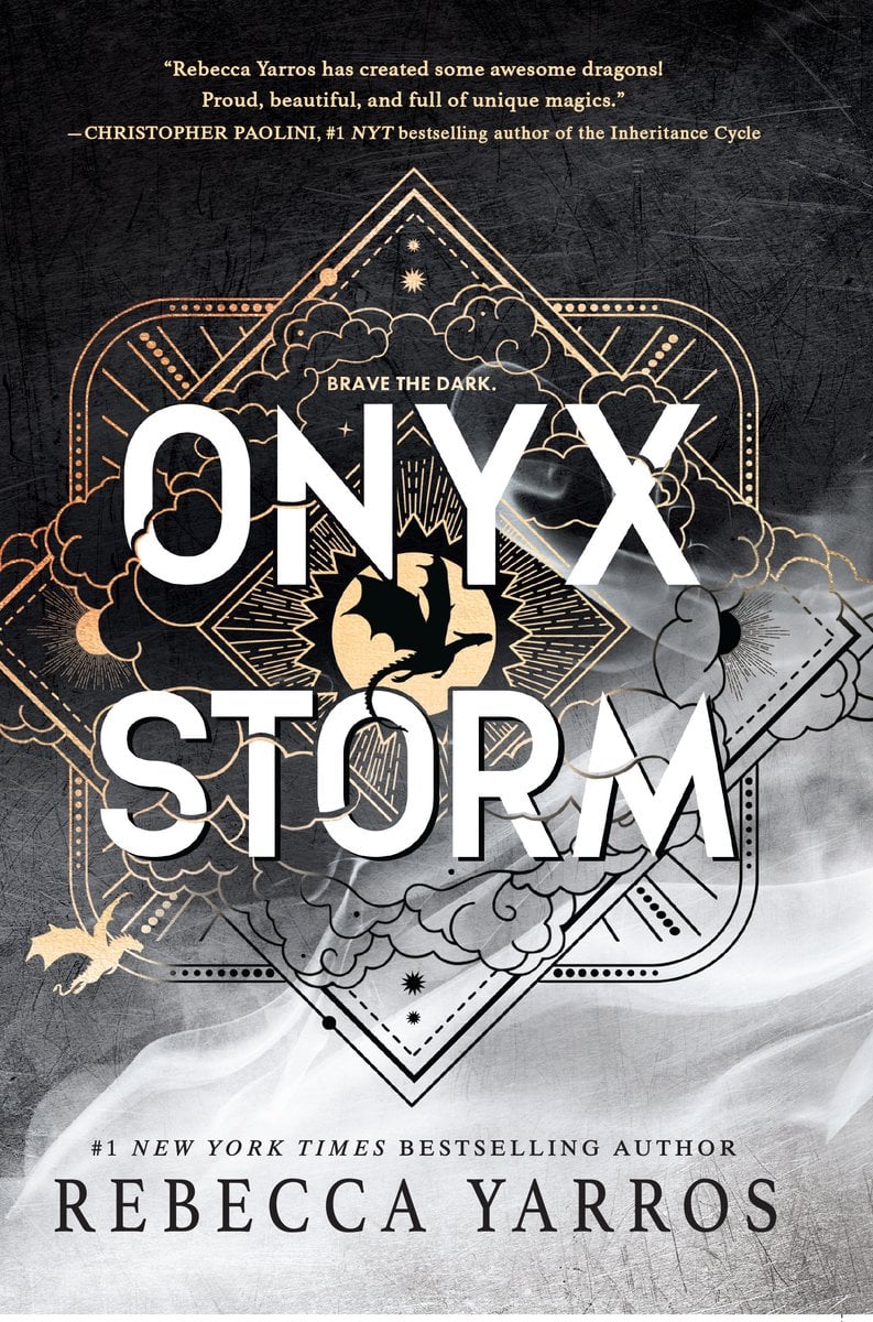 Cover of Onyx Storm by Rebecca Yarros. Half of it is black with grey and white smoke at the bottom. There is a gold outlined diamond in the center of a square, with dragons and clouds.