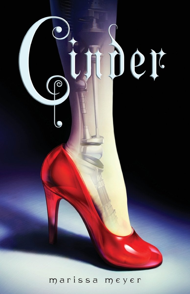 Cinder by Marissa Meyer, a young adult fiction book depicting a woman's leg wearing a red high heel and the silhouette of a robotic skeleton underneath. The leg is shown under a spotlight on a black background.