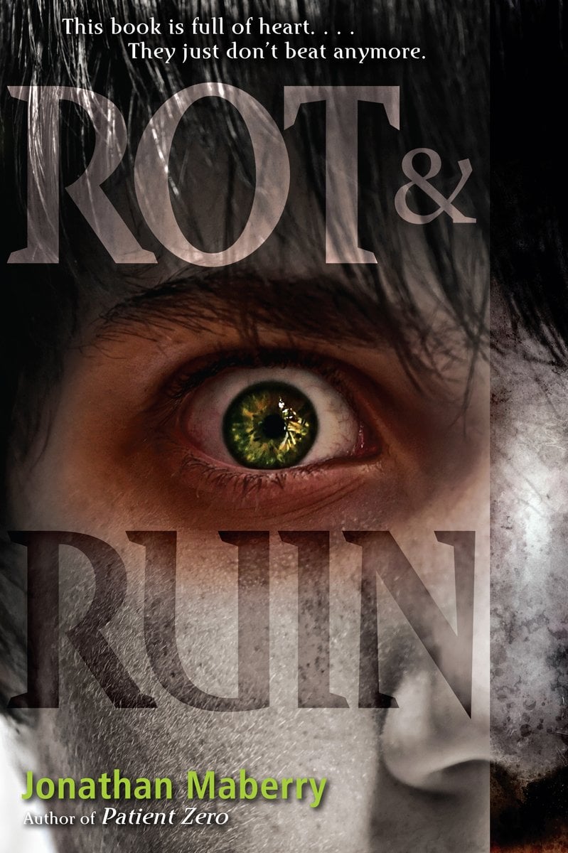 Cover of Rot & Ruin by Jonathan Maberry. The main focus is on a green eye against a dirty face and dark bangs hanging above. The eye is lined with red and black shadows.