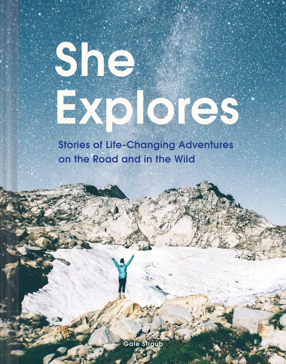 She Explores: Stories of Life-Changing Adventures on the Road and in the Wild by Gale Straub shows Straub with her arms raised as she stand on a rock in front of the starry night sky and icy mountains.