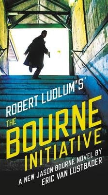 The Bourne Initiative by Robert Ludlum's, book cover. A man in a dark coat runs up the stairs holding a gun, looking over his shoulder at something behind him. Light from outside lends a green and yellow tint to the walls and a blue tint to the stairs. The title of the book is in yellow and the author's name in white and both are slanted.