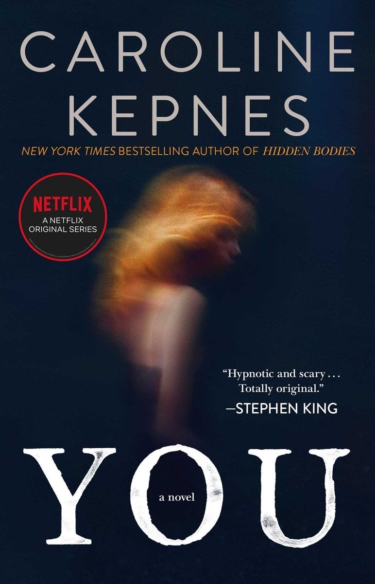 You by Caroline Kepnes, black book cover depicting a blurry image of a woman with red hair.