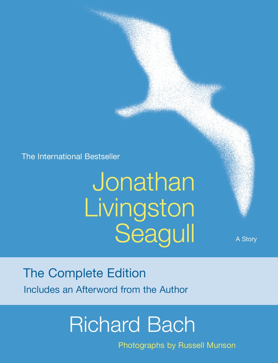 Jonathan Livingston Seagull by Richard Bach book cover. On a blue background, a seagull is depicted in pointillism style flying towards the top right corner of the page. The title is written in yellow simple font.