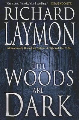 The Woods Are Dark cover by Richard Laymon, dark woods with a blue cast over them.