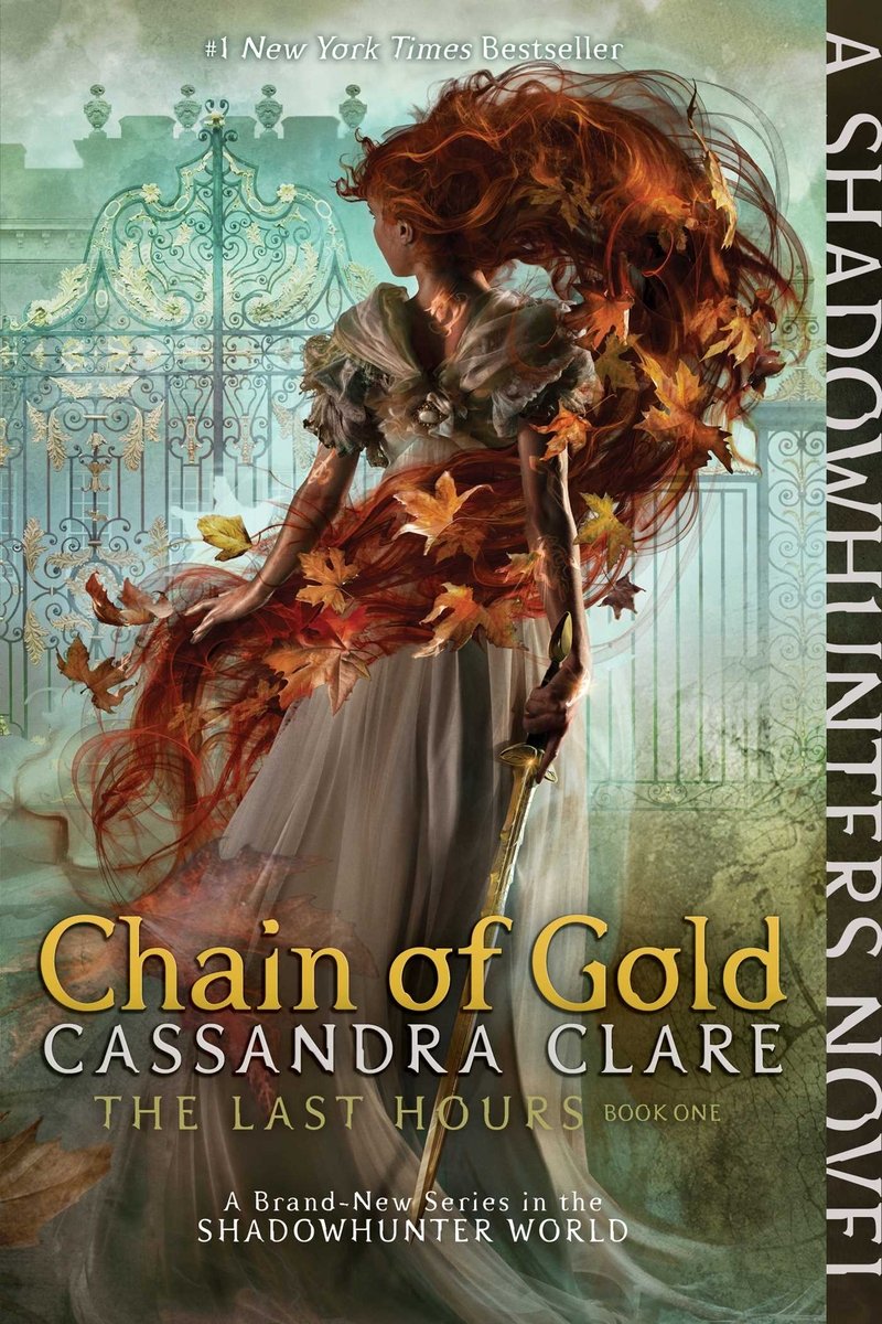 The book cover of Chain of Gold by Cassandra Clare. The cover features a girl with red hair made of leaves facing a looming mansion. She is holding a sword.