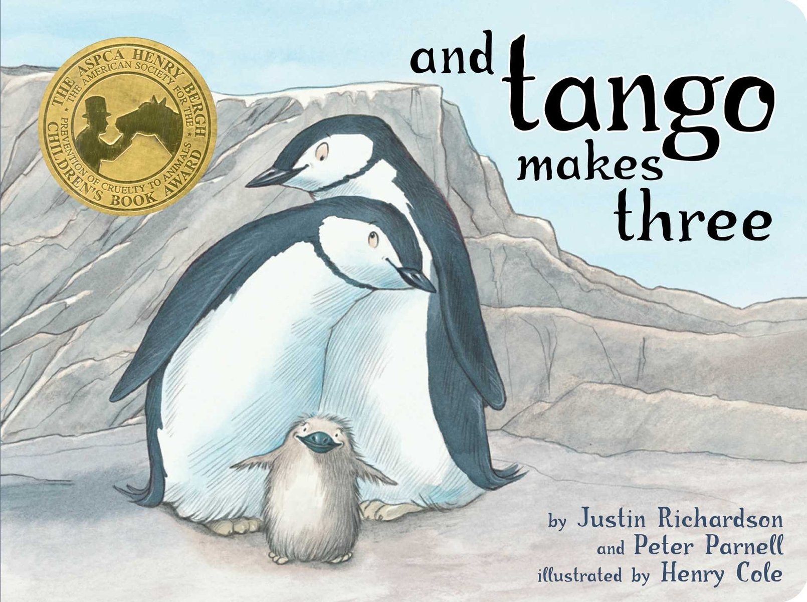 And Tango Makes Three by Justin Richardson and Peter Parnell book cover showing two adult penguins standing together forming a protective arch around a small, fuzzy chick at the center. The penguins colors are a muted color palette—blues, grays, and creamy whites—convey gentle warmth. Behind them, a pale, rocky landscape stretches under a light blue sky. The title, “and Tango makes three,” appears in lowercase, whimsical serif lettering along the top. At the bottom, the authors’ names—Justin Richardson and Peter Parnell—and the illustrator’s name—Henry Cole—are shown in smaller font.