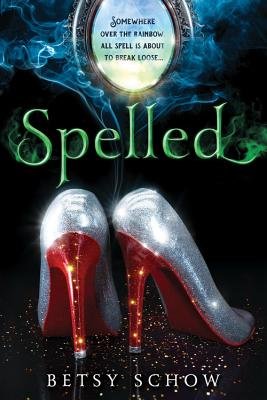 Spelled by Betsy Schow book cover. A black background with green and blue mist surrounding a pair of red and silver heels.
