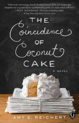 "The Coincidence of Coconut Cake" by Amy E. Reichert book cover of a chalkboard with a coconut cake on top of a stack of newspapers.