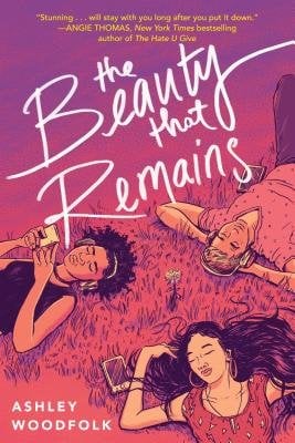 The cover of The Beauty that Remains, a YA contemporary novel, features an illustration of of two girls and a blond boy laying down in the grass. They all have headphones in and the cover is pink toned.