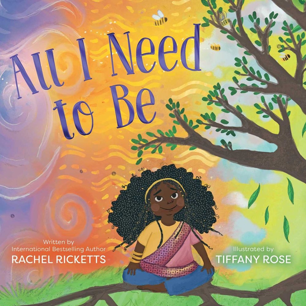The book cover of "All I Need to Be," written by Rachel Ricketts and illustrated by Tiffany Rose, features a smiling dark-skinned girl with natural coily-textured hair and braids framing her face sitting cross-legged on a tree branch and staring up at an orange and purple swirly sky.