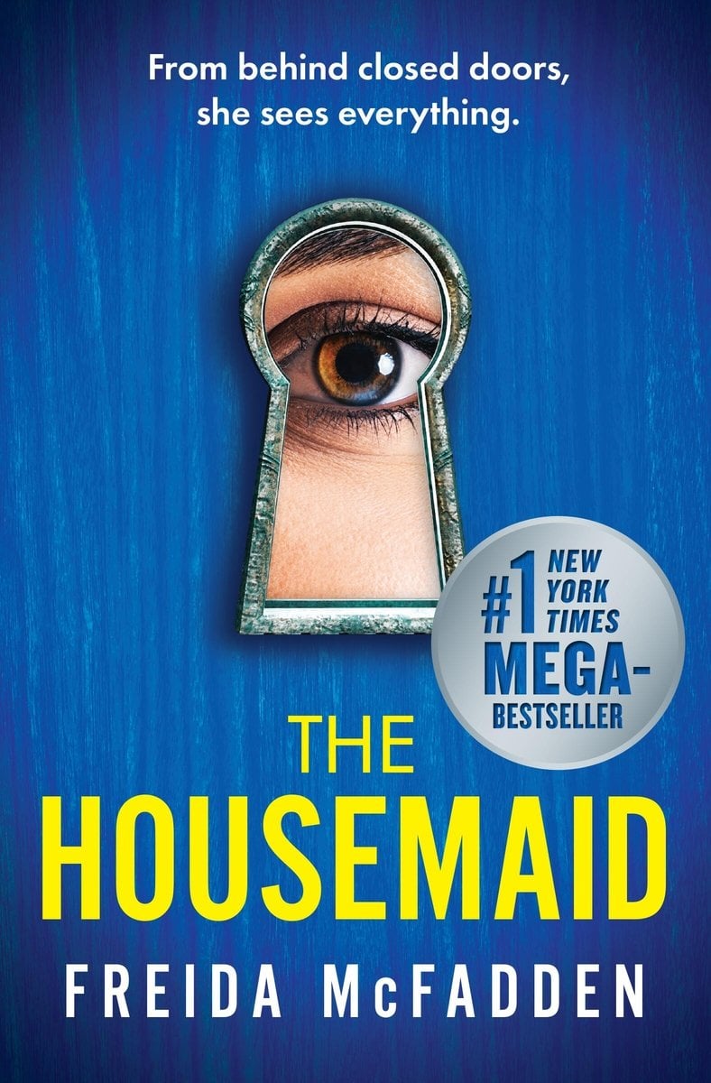 The Housemaid by Freida McFadden, a thriller novel cover, The cover depicts a blueish-hazel colored eye peering through a keyhole. It is set against a deep blue background.