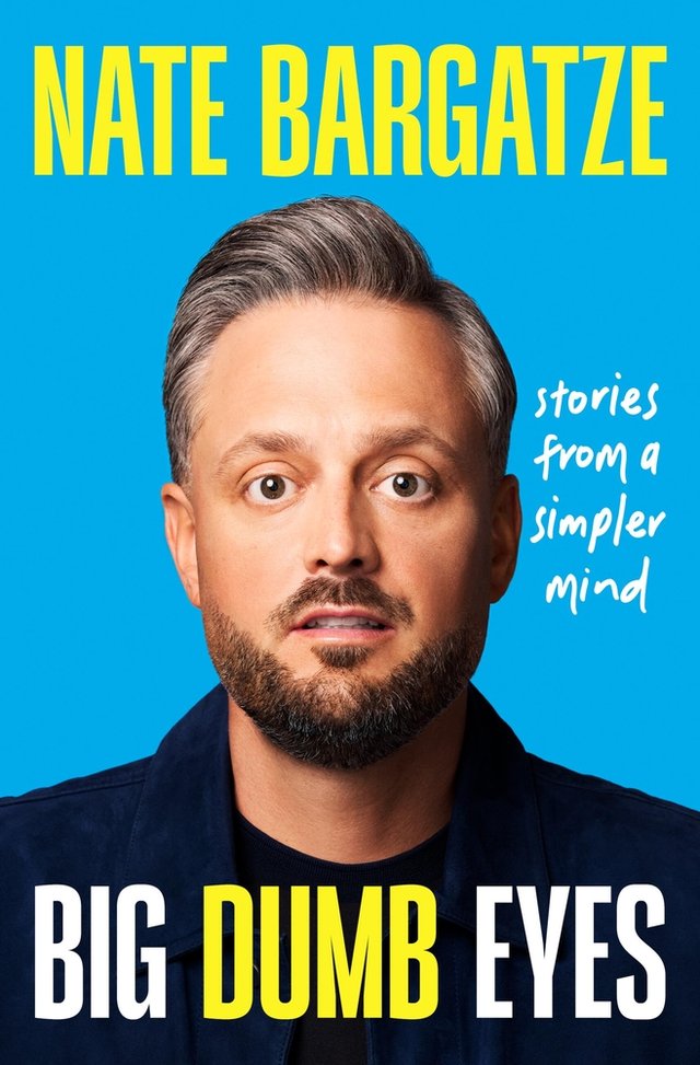 Big Dumb Eyes: Stories from a simpler mind by Nate Bargatze, a nonfiction book cover featuring Nate Bargatze in the center with wide-spread and vacant eyes in front of a light blue background.