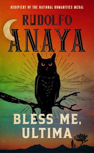 Bless Me, Ultima by Rudolfo Anaya. A black owl is in the middle of the cover sitting on a branch, and the background is a rainbow sky. Two figures holding hands, one small and one taller, can be seen in the background holding hands.